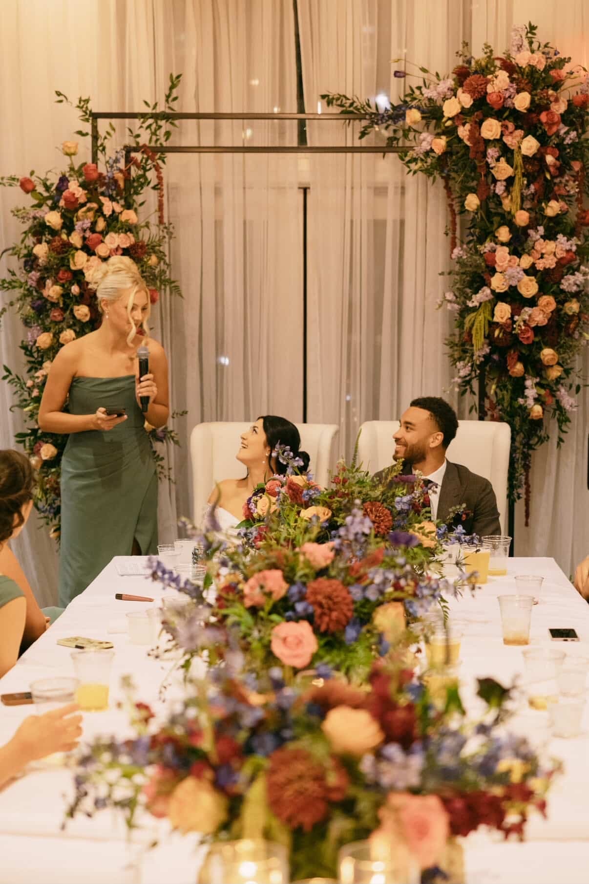 Wedding reception with floral arch and centerpieces at Bash, Des Moines, Iowa