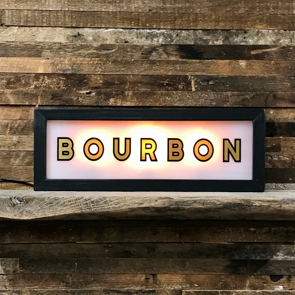 Black wood-framed lighted sign reading "Bourbon," sold at Thistles in Pella, Iowa