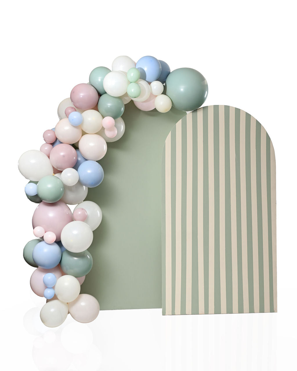 Pastel balloon garland arch in sage green, dusty pink, cream, and dusty blue, draped over a two-tone arch backdrop — solid sage green on the left panel and cream-and-sage stripes on the right.