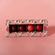 Four artisan chocolate truffles from Garden Square Chocolatier, handmade at Thistles Flower Market, arranged in a gift box