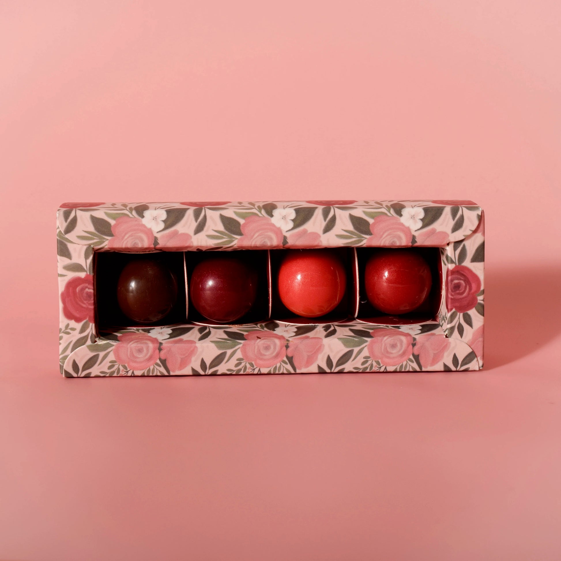 Four artisan chocolate truffles from Garden Square Chocolatier, handmade at Thistles Flower Market, arranged in a gift box
