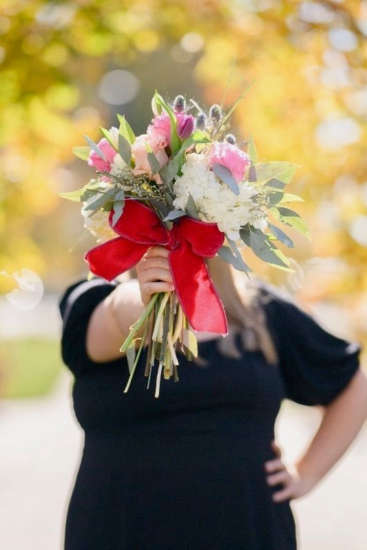 Floral wrap tied with a large decorative bow, made by Thistles Flower Market in Pella, Iowa