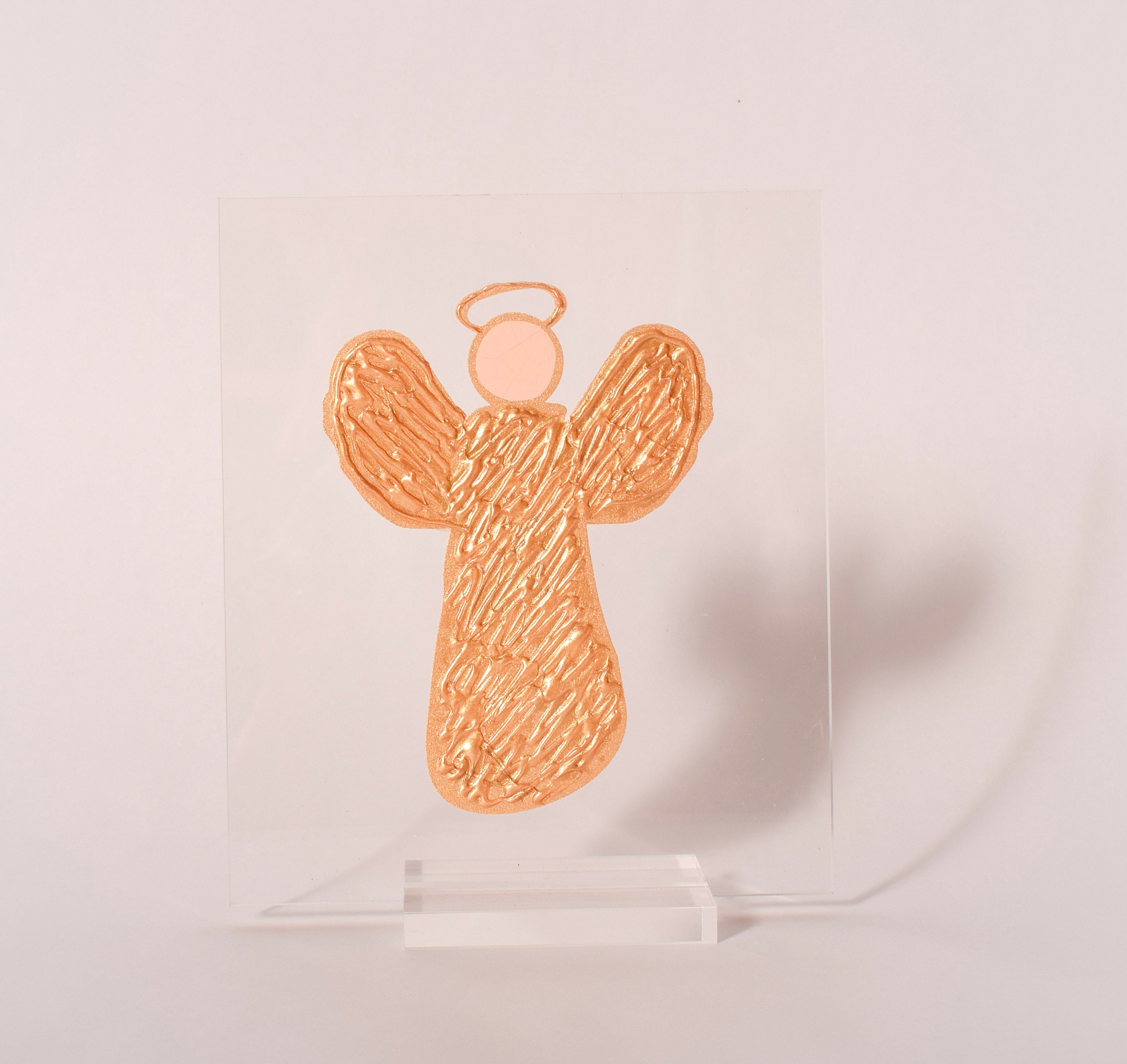 Gold angel acrylic plaque displayed in a clear acrylic stand, sold at Thistles in Pella, Iowa