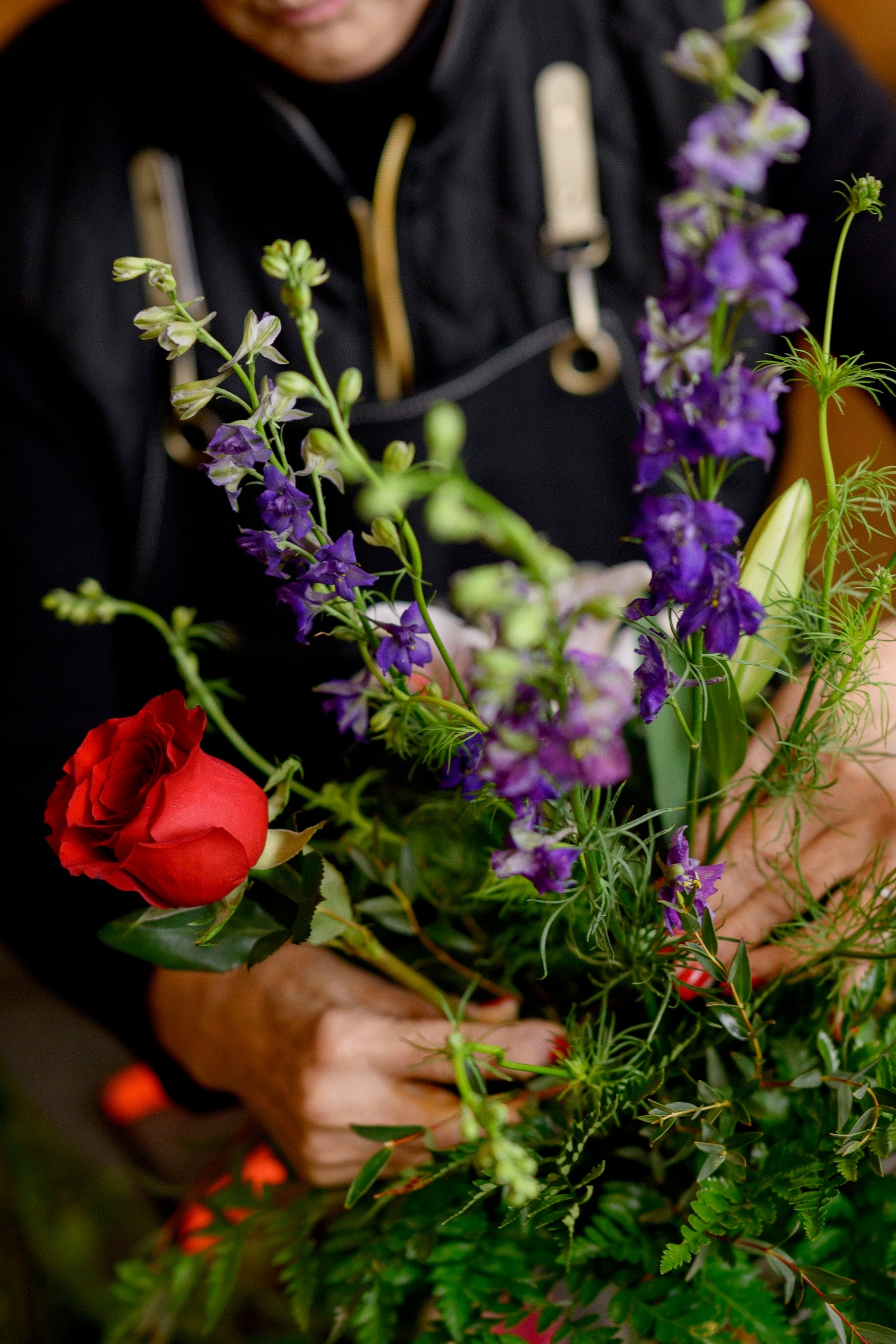 Close-up of hands arranging a floral bouquet during a flower arranging class in Pella, Iowa