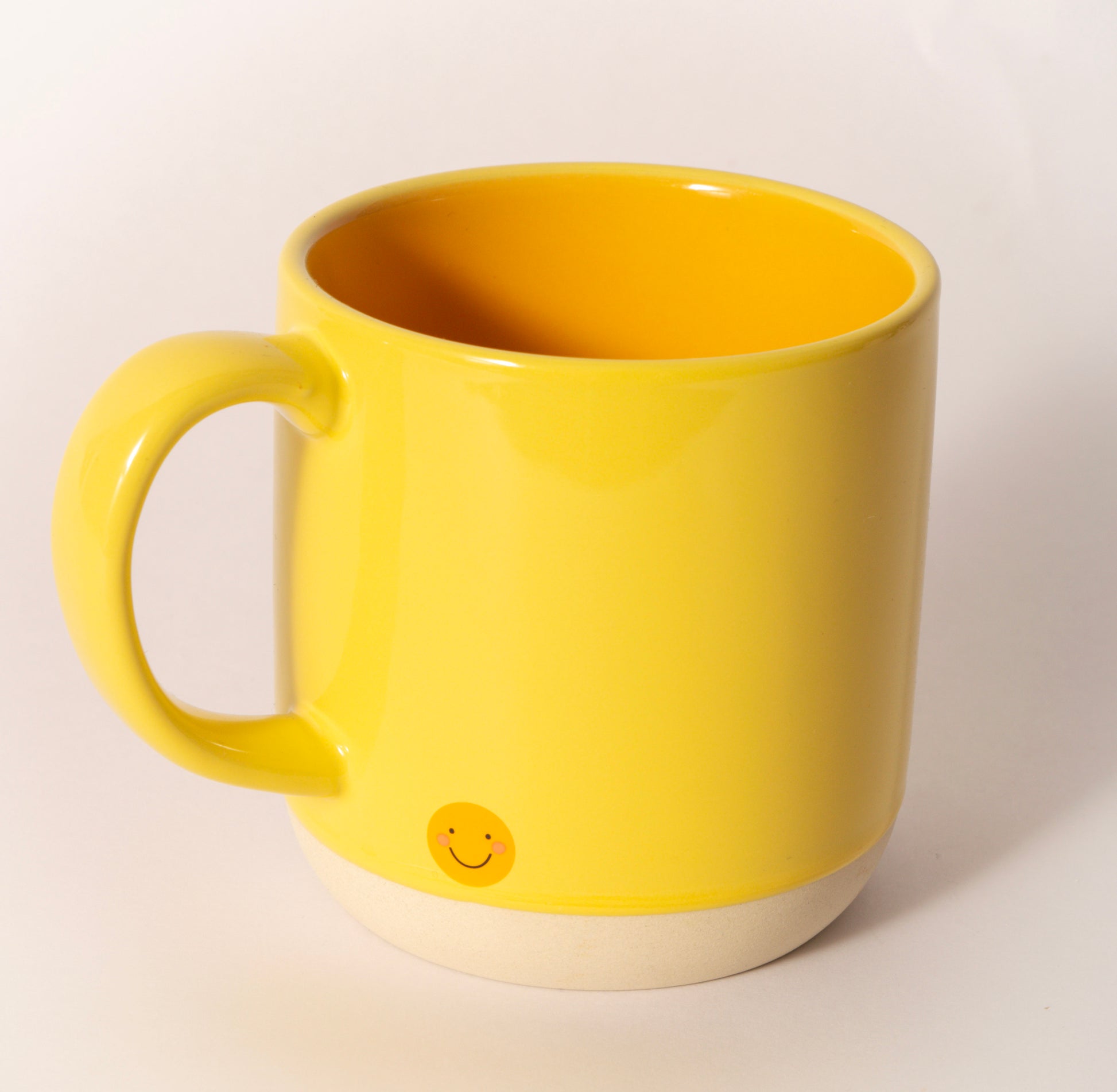 Yellow ceramic coffee mug printed with "Hi Beautiful," sold at Thistles in Pella, Iowa