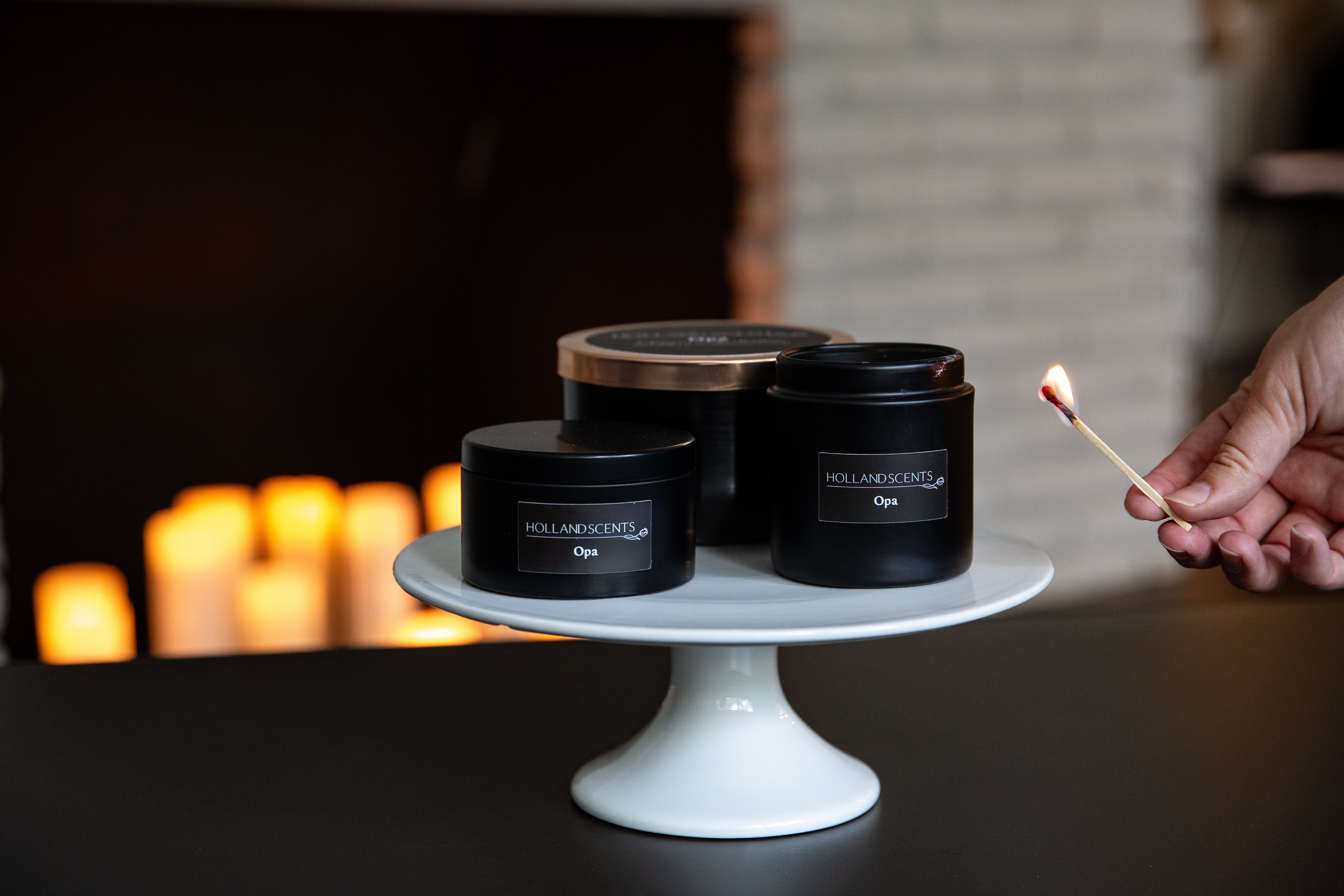 Holland Scents Canals of Amsterdam soy candle in three sizes displayed on a cake stand, Pella, Iowa