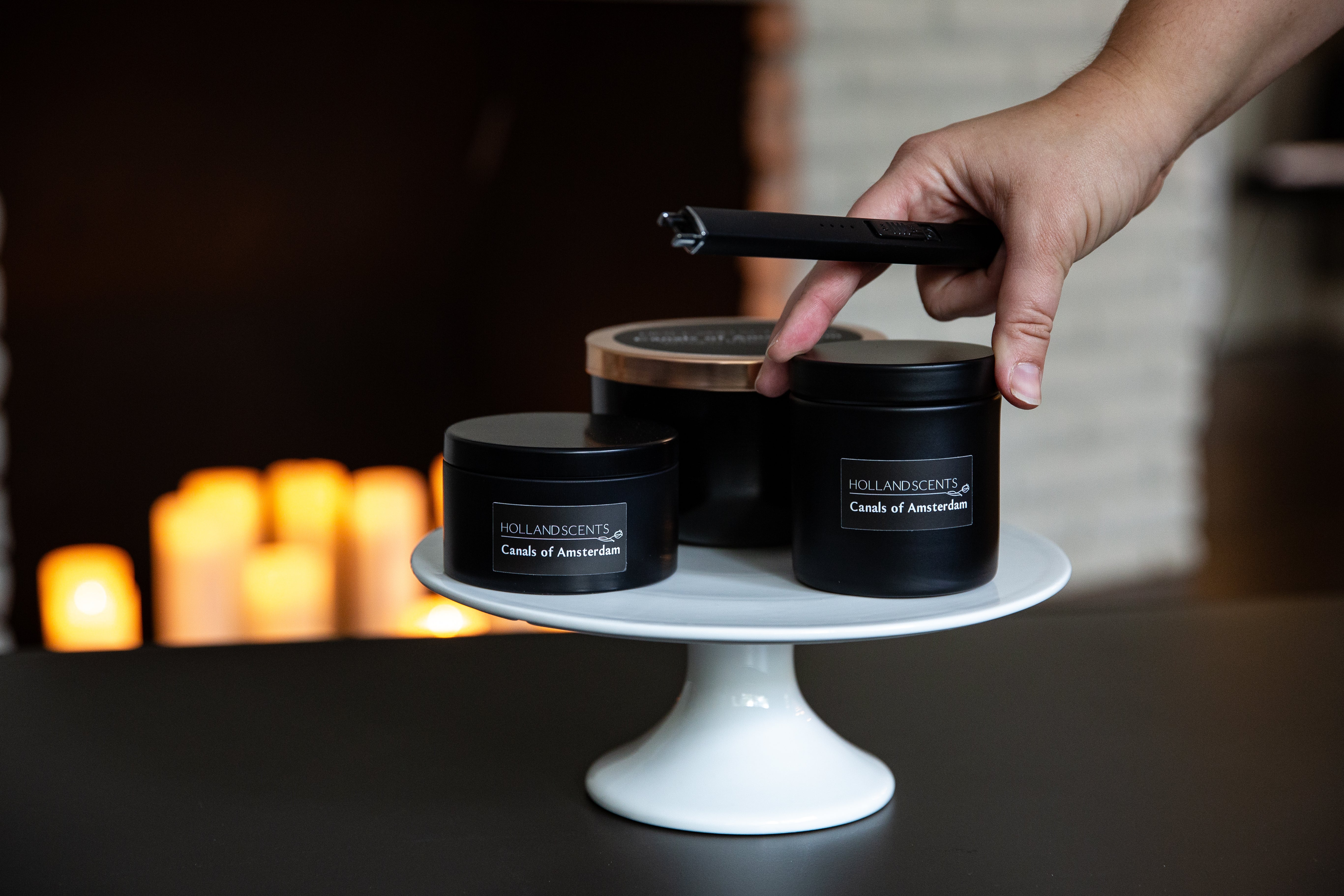 Holland Scents Canals of Amsterdam soy candle in three sizes displayed on a cake stand, Pella, Iowa
