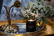 Holland Scents Delft soy candle lit beside blue and white Delft pottery and flowers, Pella, Iowa
