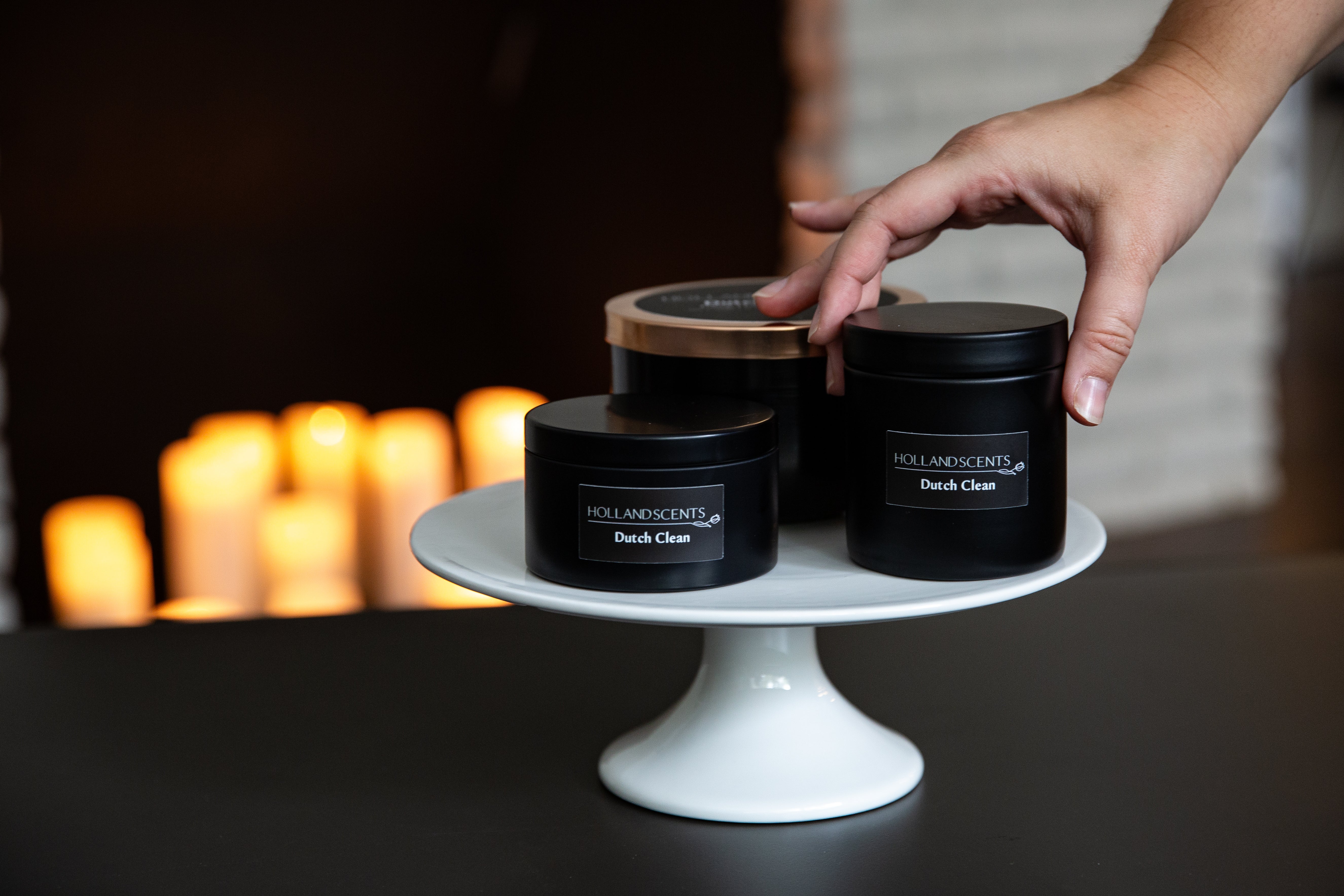 Holland Scents Dutch Clean soy candle in three sizes displayed on a cake stand, Pella, Iowa