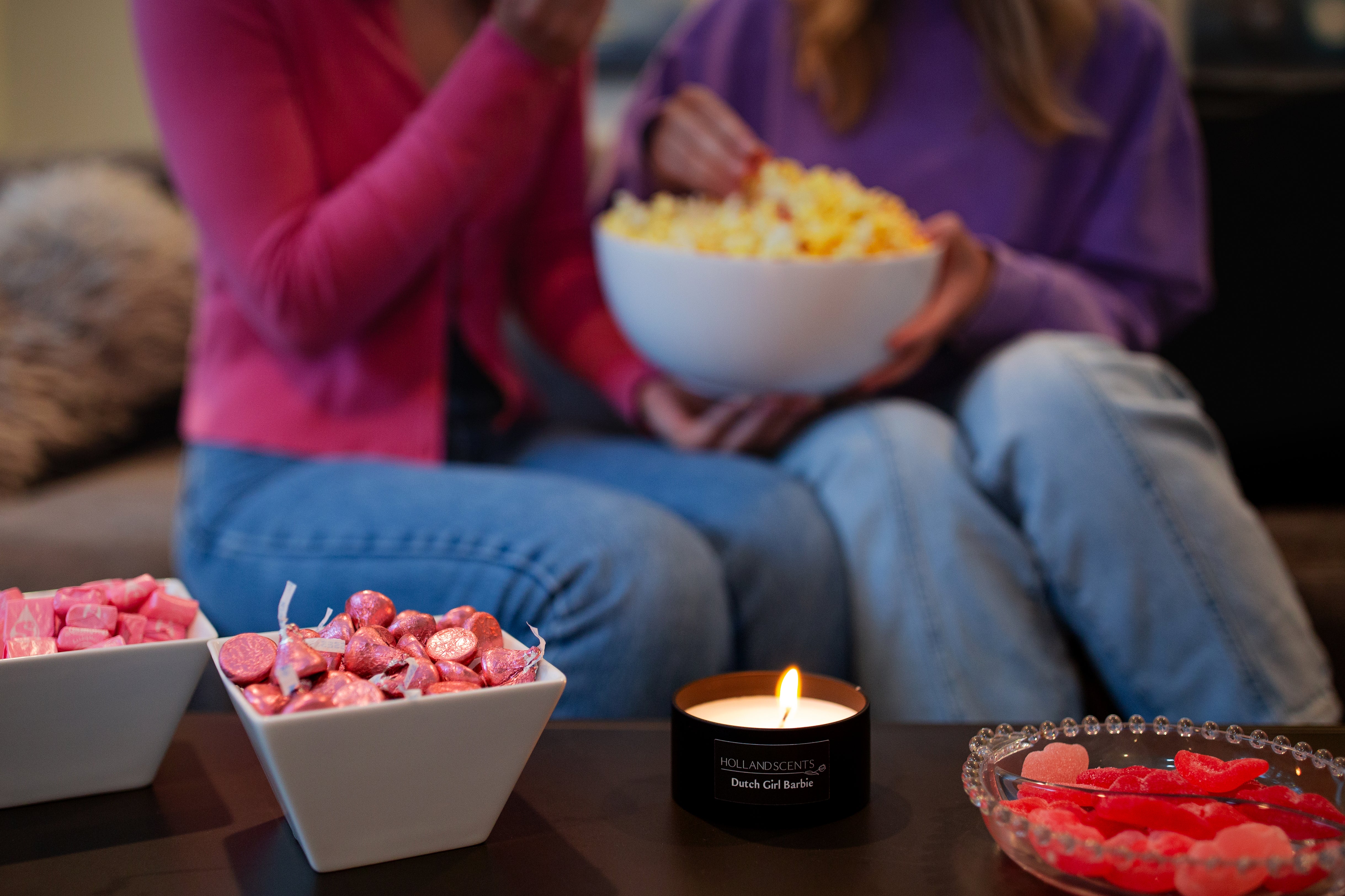Holland Scents Dutch Girl soy candle lit on a table with pink candy and popcorn, Pella, Iowa