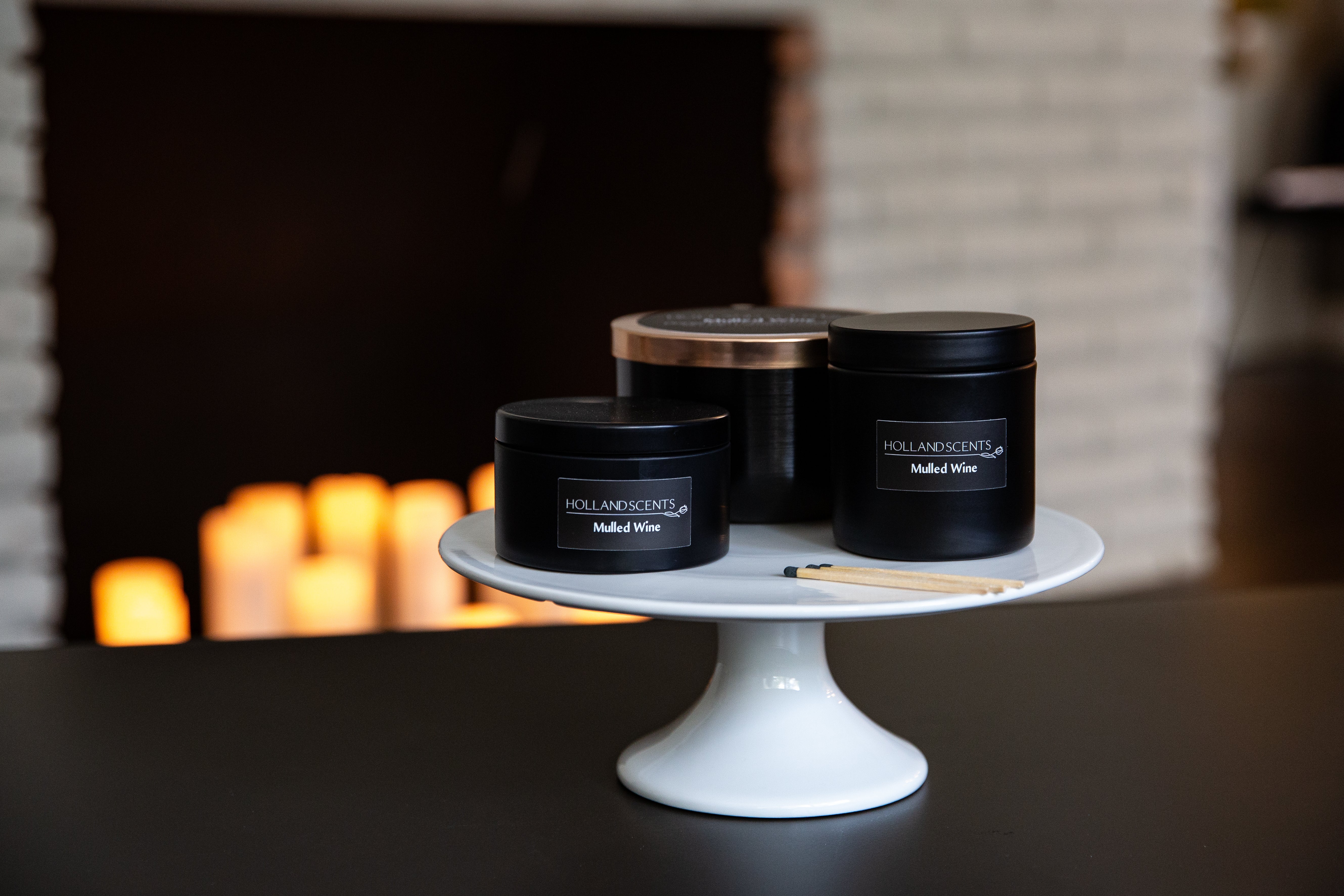 Holland Scents Mulled Wine soy candle in three sizes displayed on a cake stand, Pella, Iowa