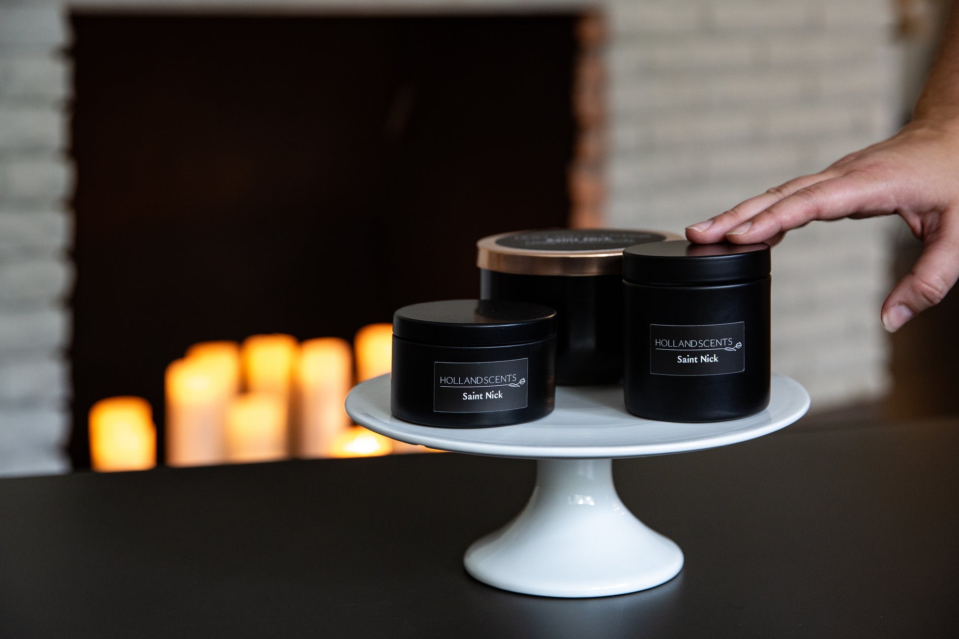 Holland Scents Saint Nick soy candle in three sizes displayed on a cake stand, Pella, Iowa