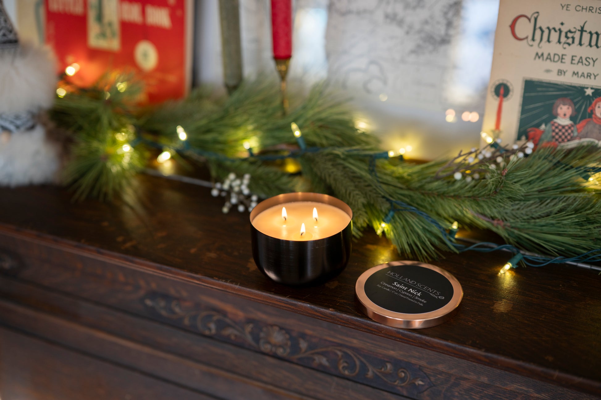 Holland Scents Saint Nick soy candle with vintage Christmas decor and pine garland, Pella, Iowa