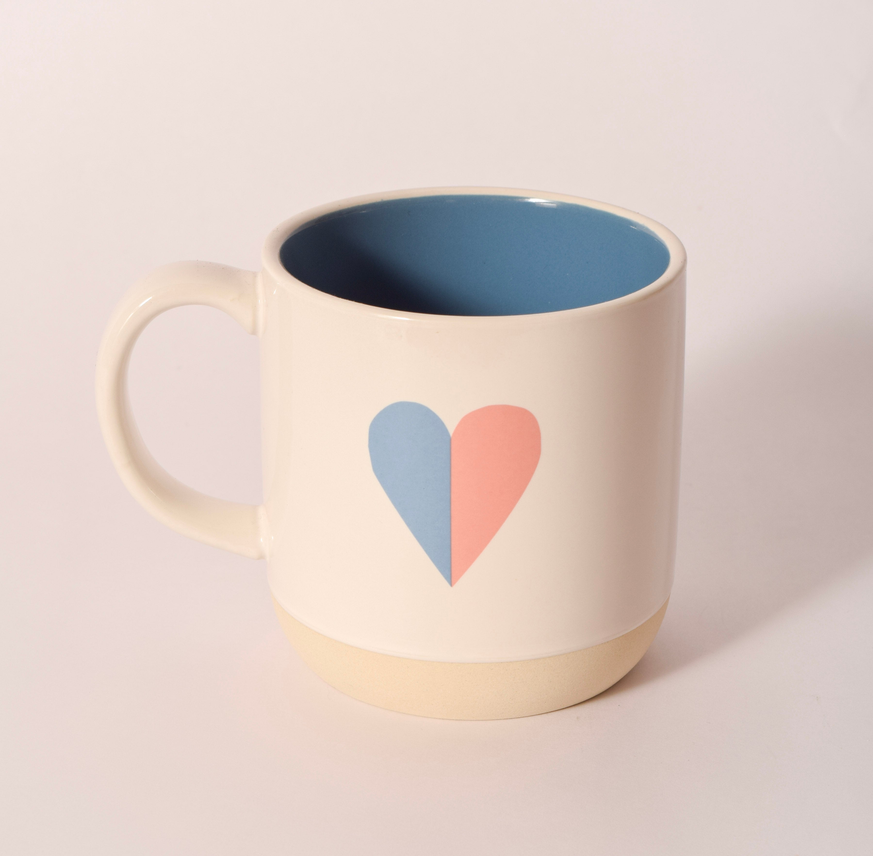 White ceramic mug with colorful "LOVE" lettering, sold at Thistles in Pella, Iowa