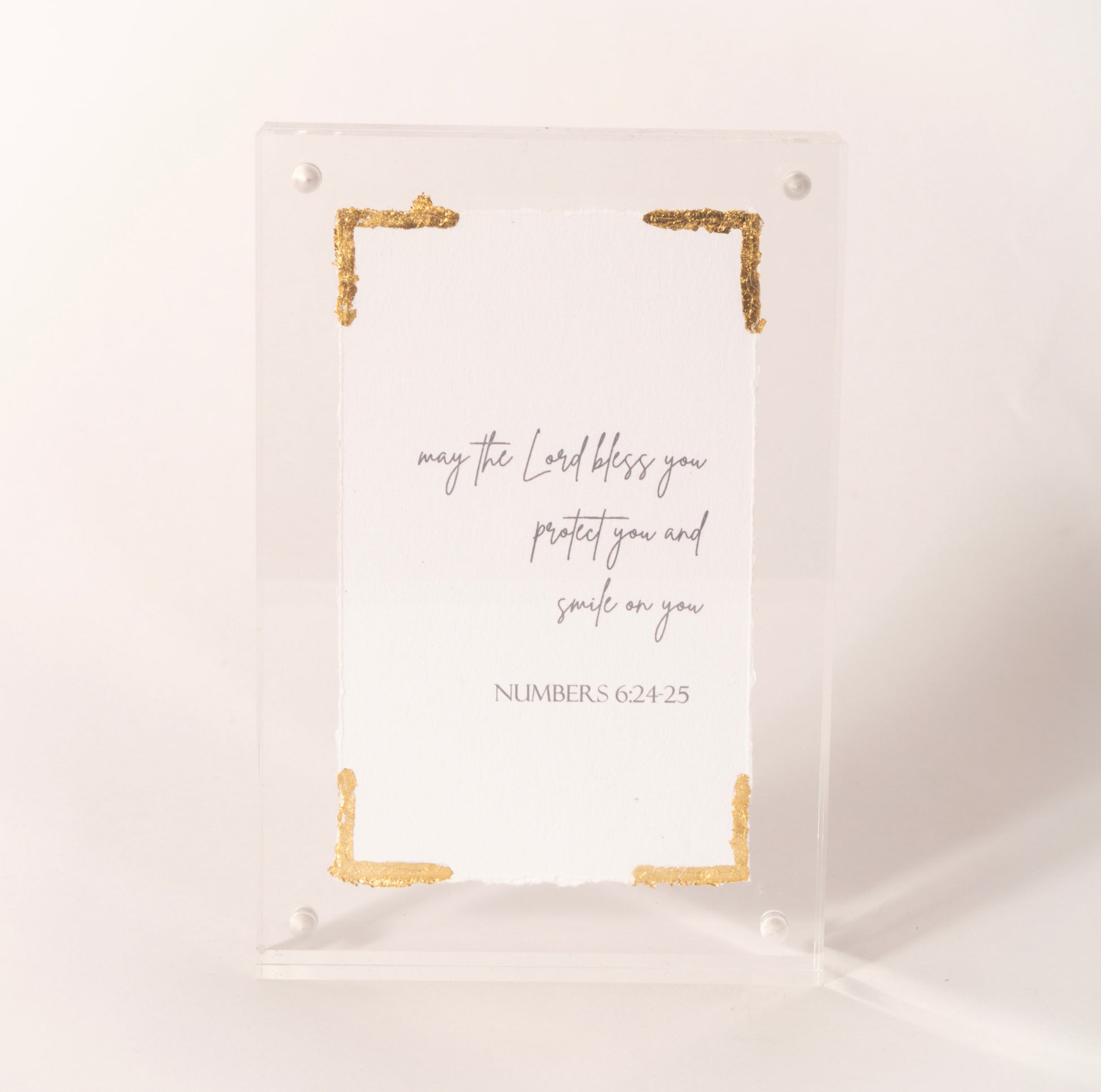 Clear acrylic plaque with gold corners inscribed with the Numbers 6:24-25 blessing, sold at Thistles in Pella, Iowa