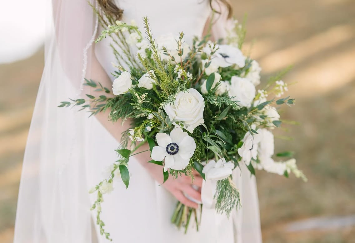 Green and white bridal bouquet with anemone from Thistles Flower Market at Gathering Grounds, Pella, Iowa