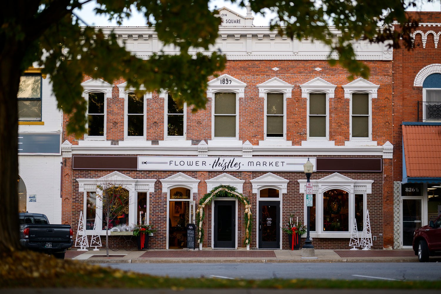 Thistles Flower Market's 1897 building on Pella, Iowa's Central Park, inscribed "On Garden Square" above the door